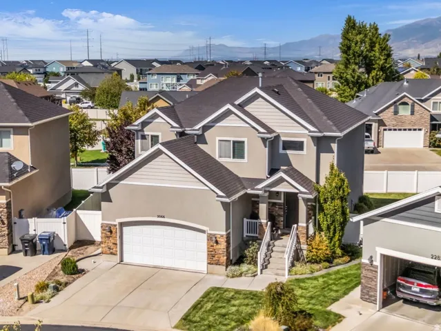 Two-story homes with attached garages, paved driveways, and manicured landscaping
