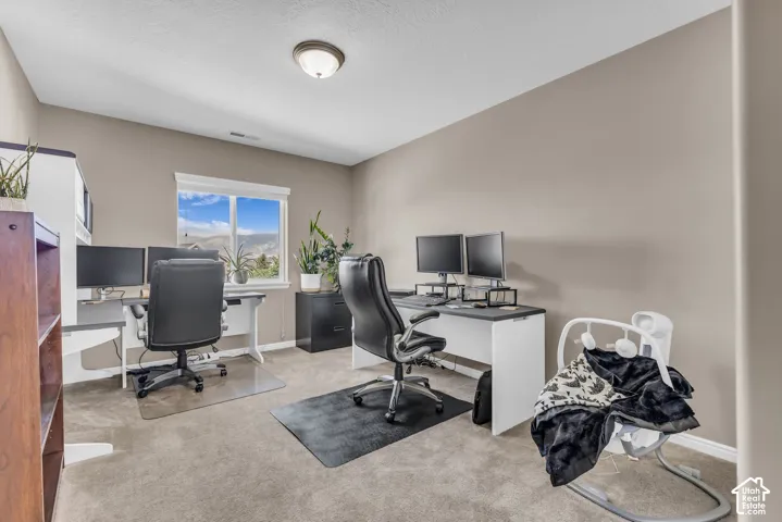 Room featuring neutral wall tones, recessed lighting, a window with exterior scenery, and carpet flooring
