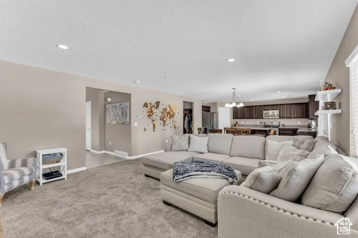 Recessed lighting, neutral wall tones, and carpeted flooring