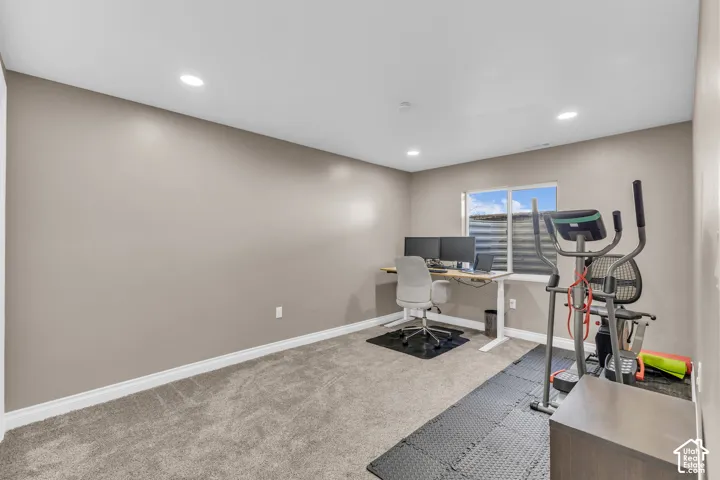Recessed lighting, neutral wall paint, white trim, window with blinds, and carpet flooring