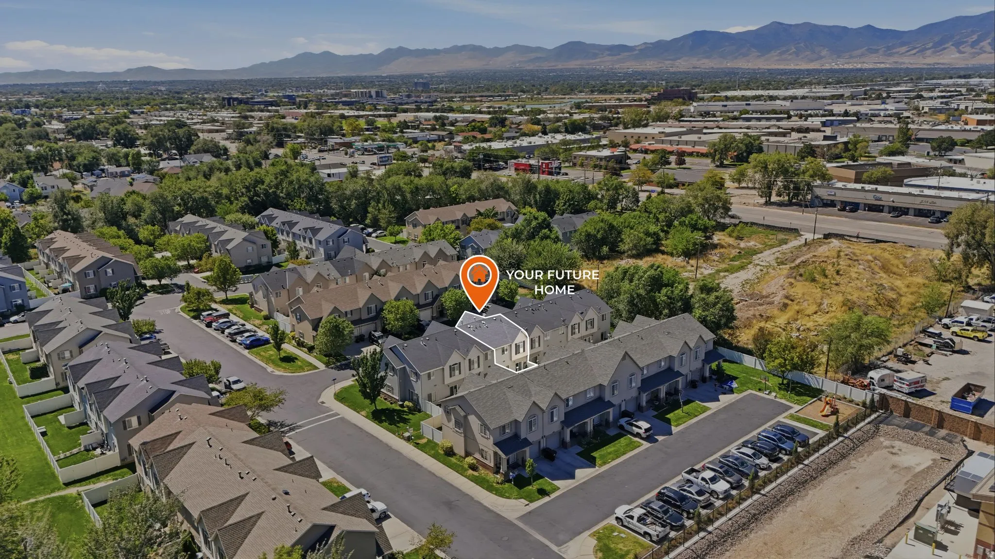 Townhome community with paved parking areas and landscaping