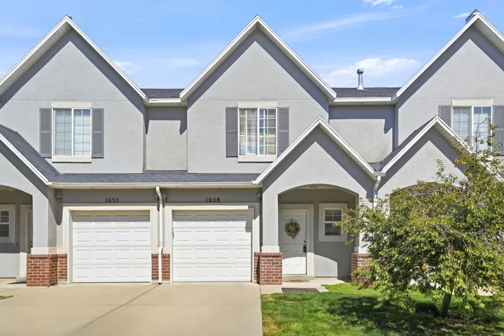 Stucco exterior with brick detailing and white trim