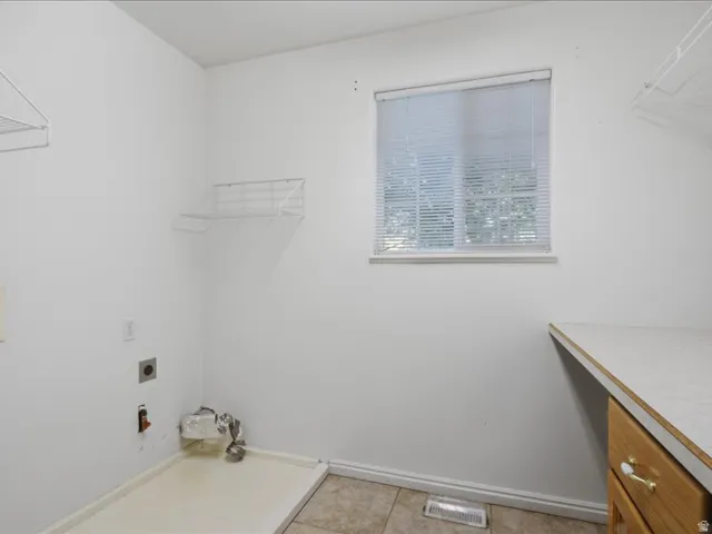 Tiled flooring and a window with blinds