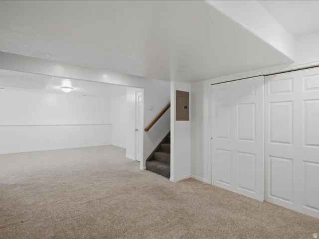 Carpeted flooring throughout, recessed ceiling light, white panel doors, and neutral wall tones