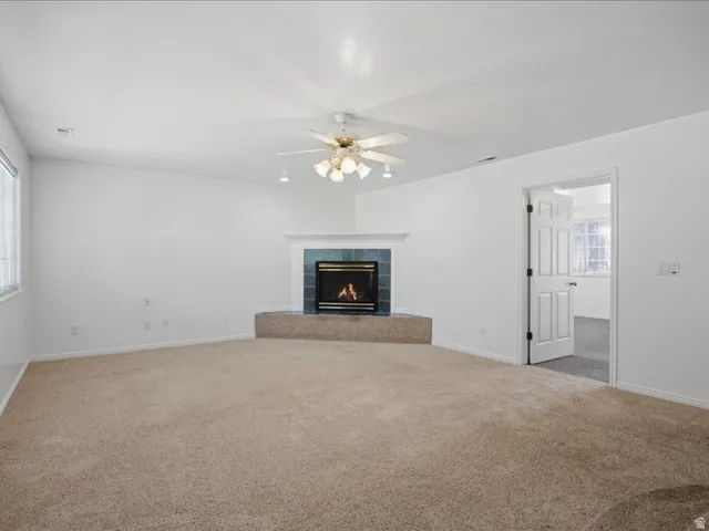 Corner gas fireplace with a tiled surround and mantel