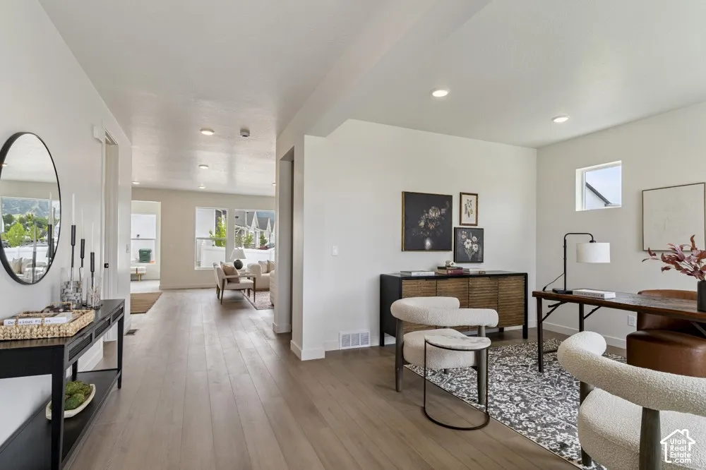 Light wood-finish flooring, recessed lighting, and a square window in a private room