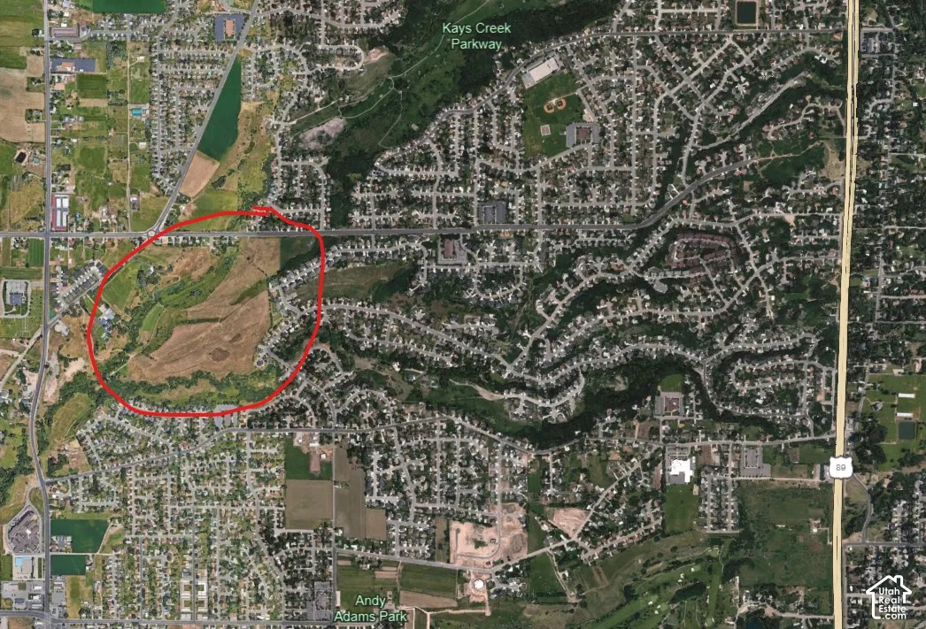 Aerial Map. Depicting a land parcel outlined in red within a developed area