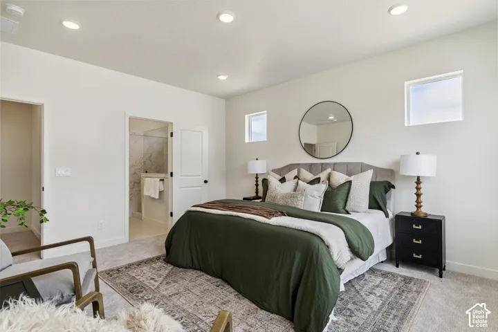 Recessed ceiling lighting, two upper windows, and a carpeted floor
