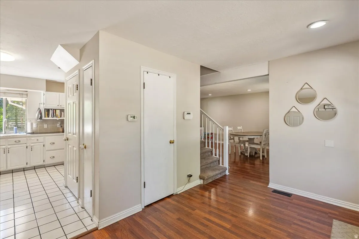 Kitchen with white cabinetry and tile flooring