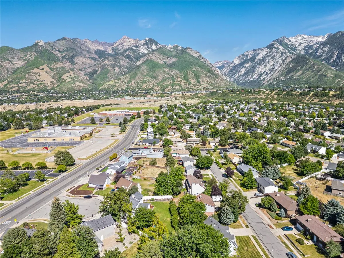 Expansive residential area featuring established homes, mature trees, and mountainous topography