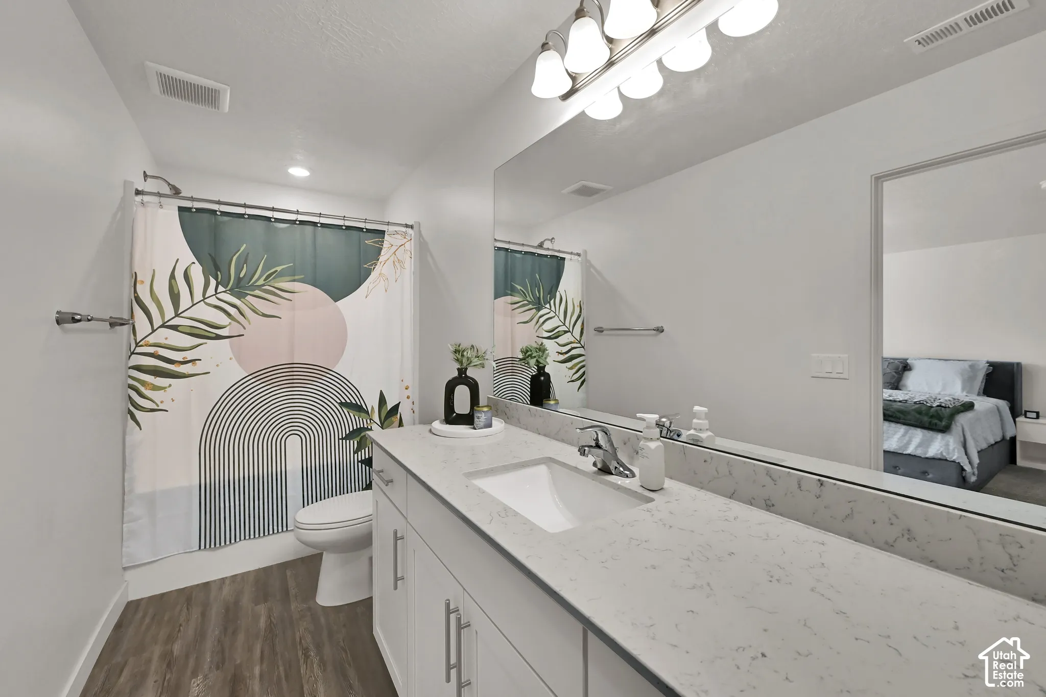 Spacious vanity with a light-toned countertop, undermount sink, and chrome faucet