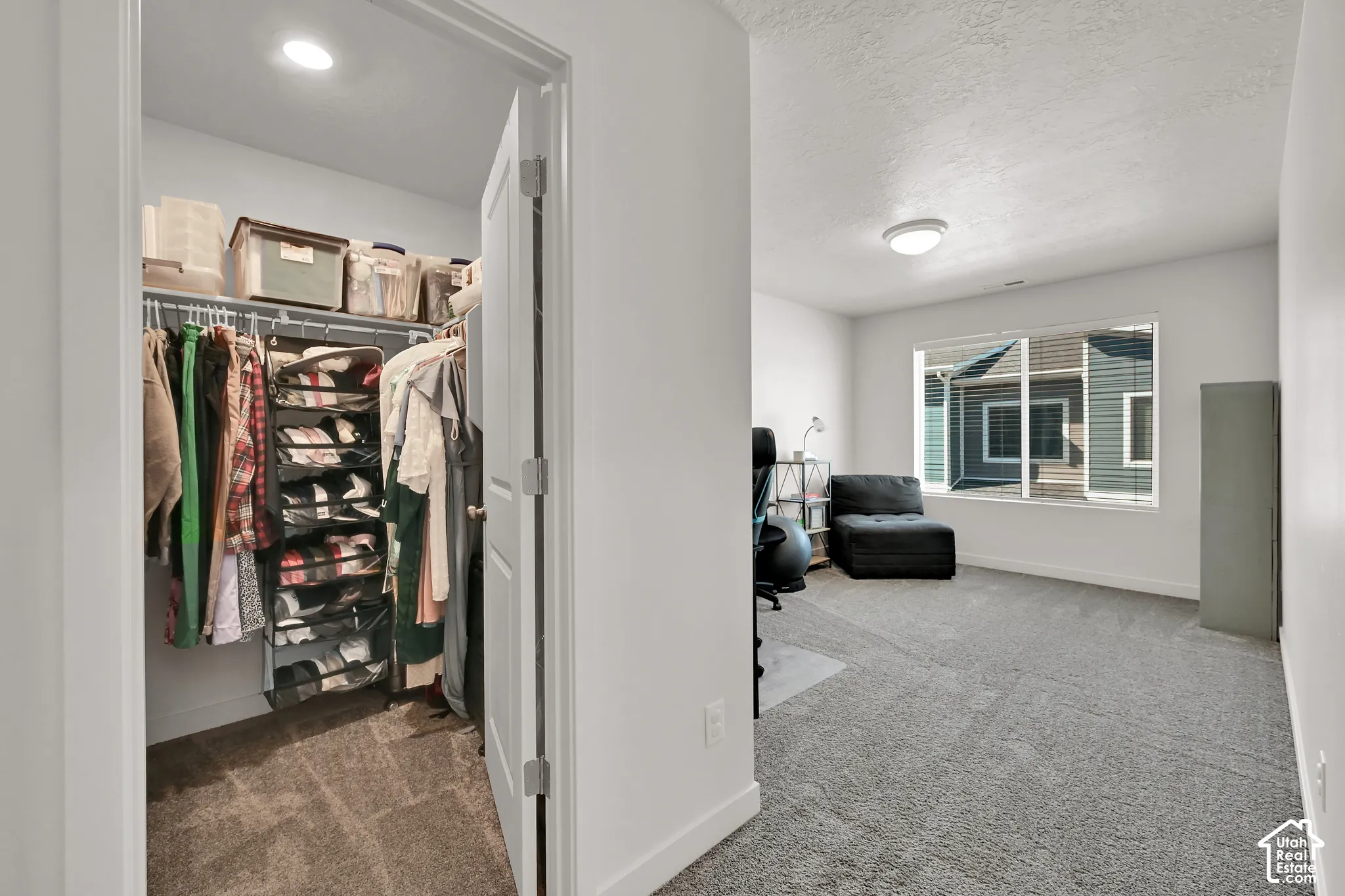 Recessed ceiling light, carpet flooring, and a window with horizontal blinds