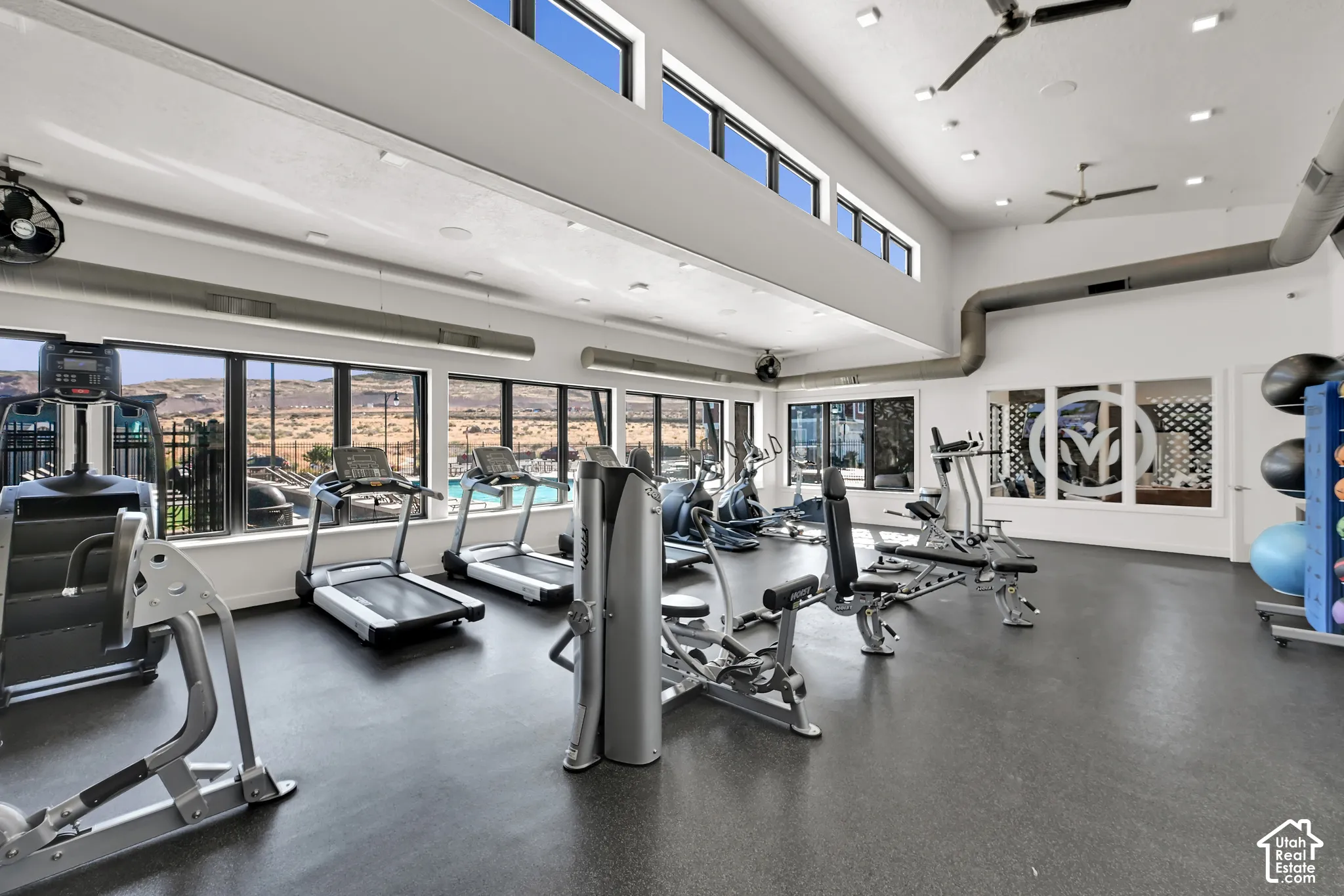 Dedicated fitness space featuring a high vaulted ceiling, clerestory windows, and panoramic exterior windows