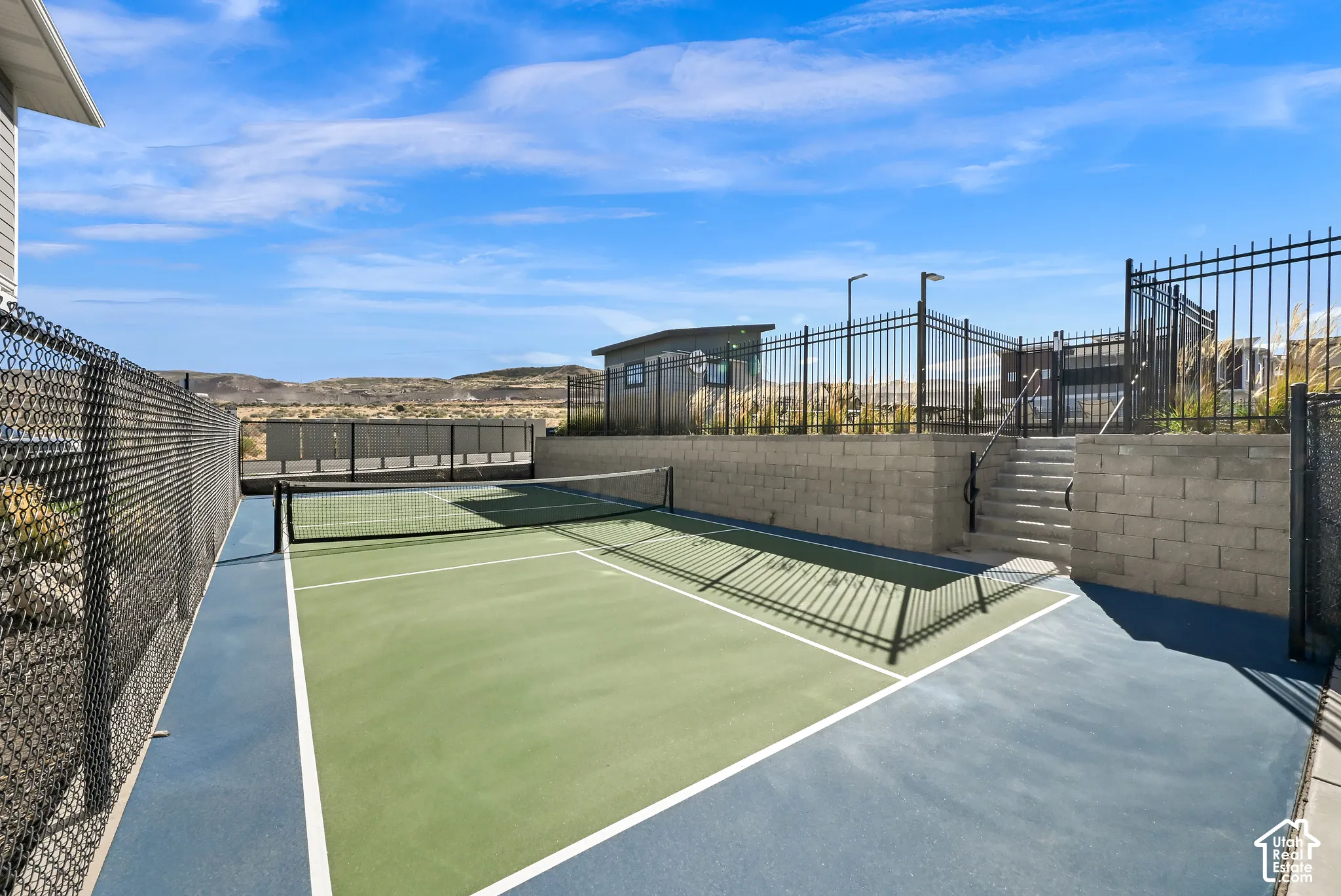 Fenced pickleball court with a hard-surface finish