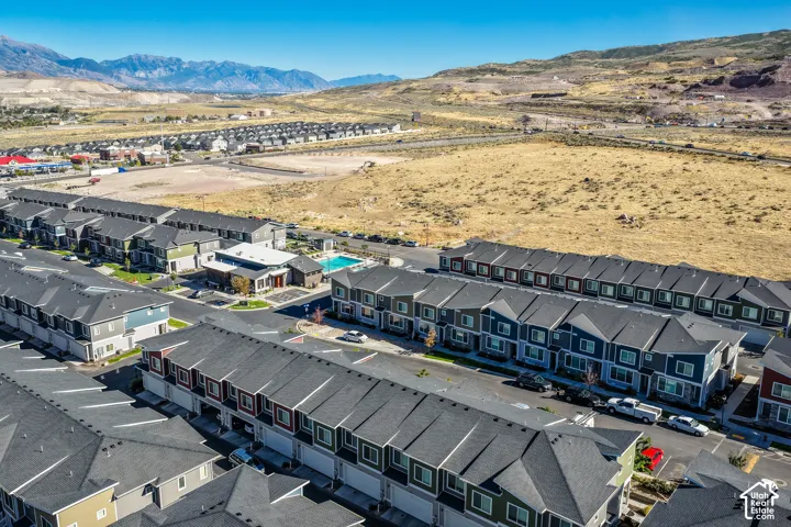 Community featuring multiple multi-story residential buildings, a central clubhouse, and an outdoor swimming pool