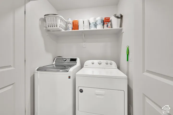 Dedicated laundry area featuring a built-in shelf for storage and a white paneled door