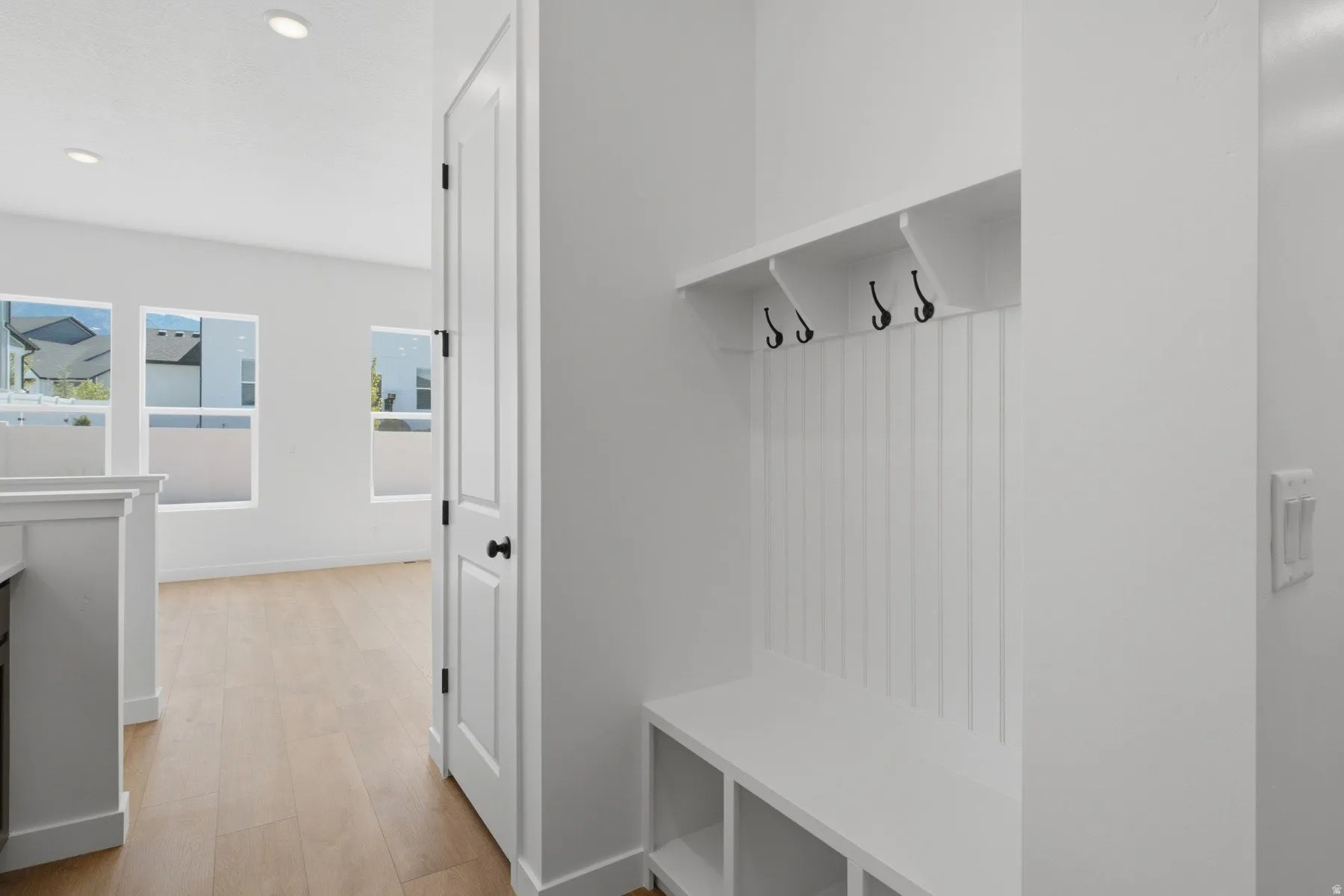 Built-in mudroom bench with coat hooks and storage cubbies