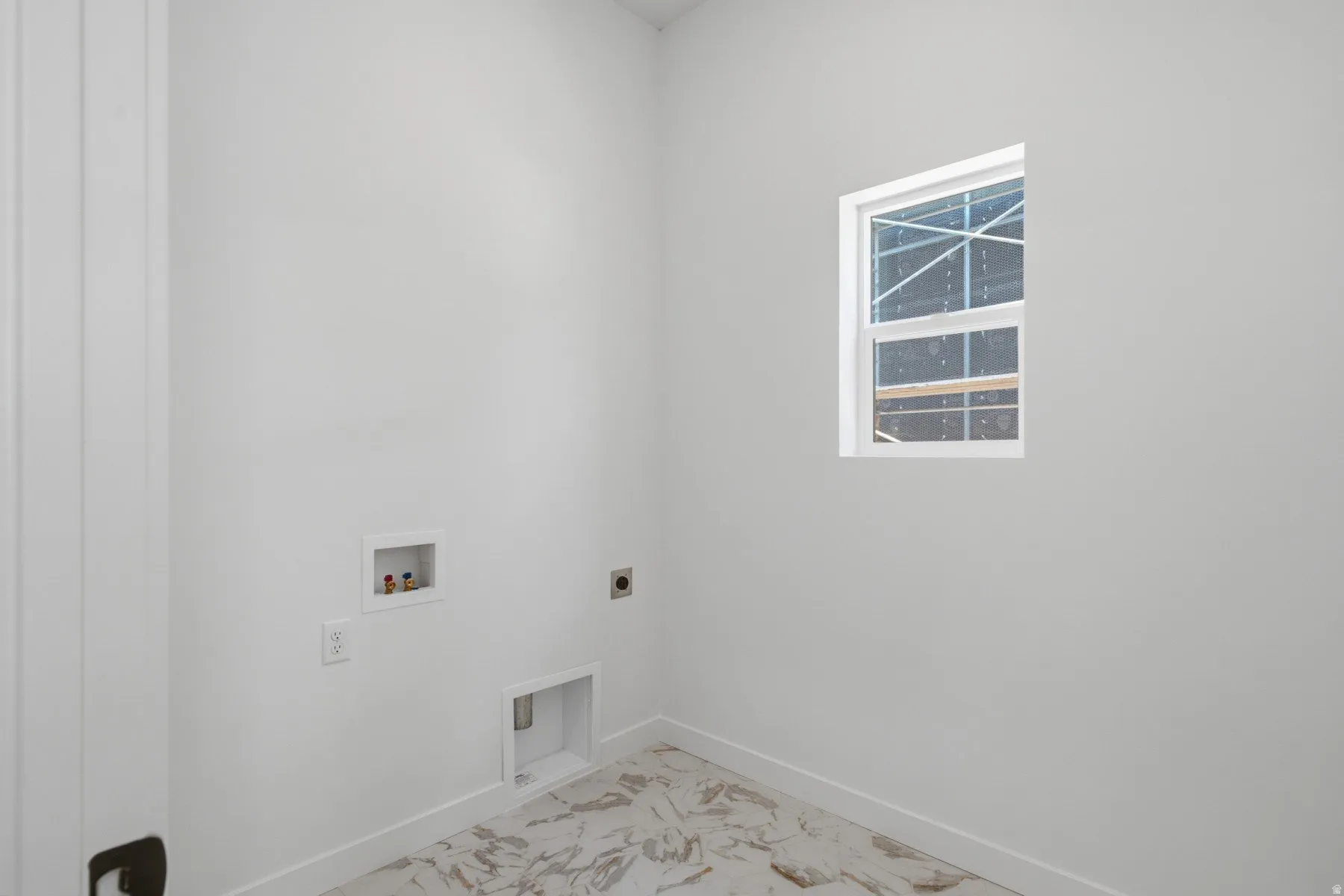 White framed window, white walls, and marble-finish flooring