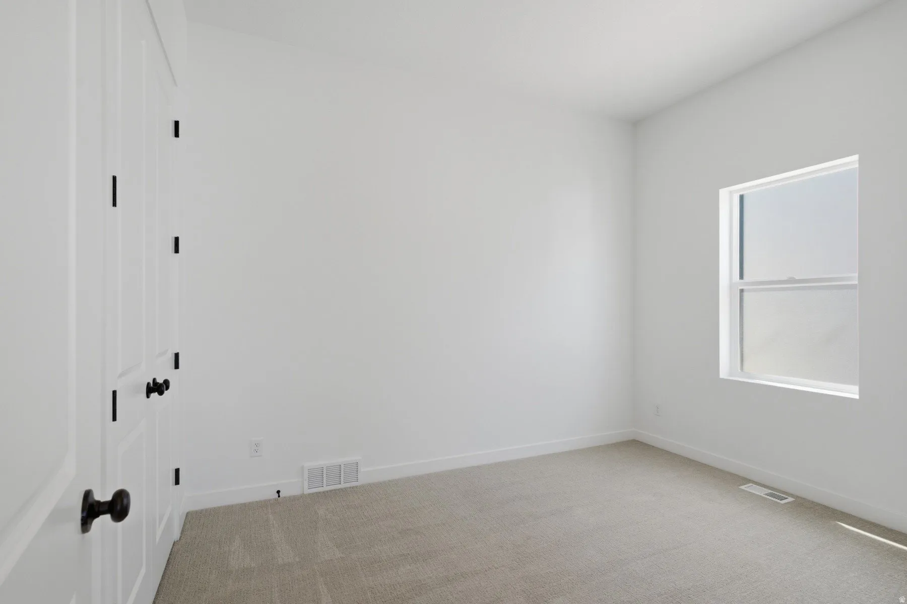 White walls and carpeted flooring