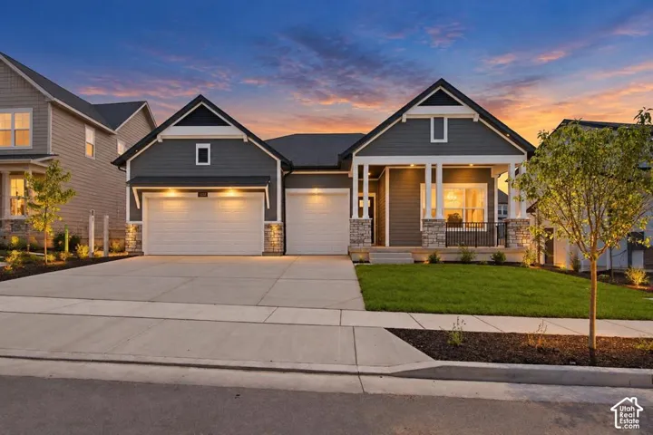 Contemporary exterior with dark siding, stone accents, and a covered porch