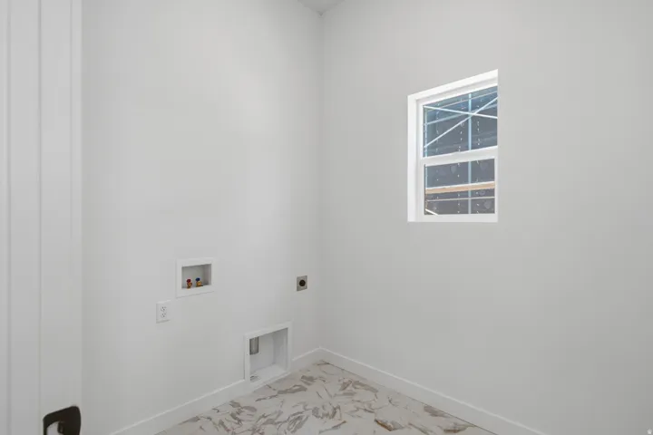 White framed window, white walls, and marble-finish flooring