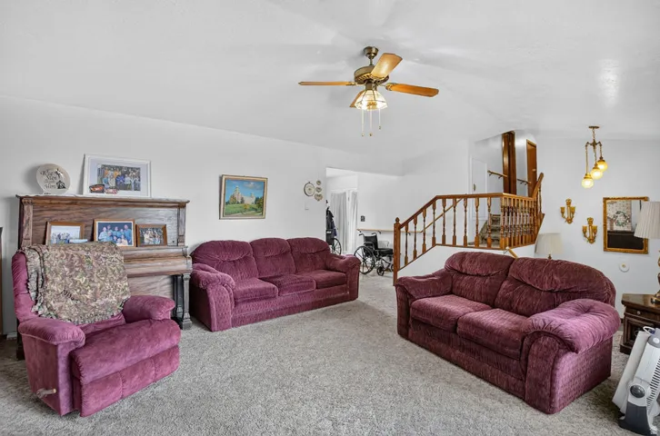 Ceiling fan with integrated lighting, wood railing and balusters, and overhead lighting fixture