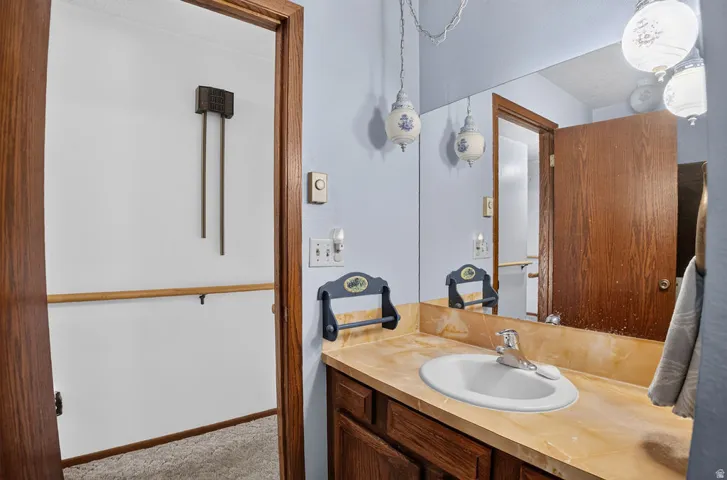 Integrated vanity with an oval sink, polished chrome faucet, and a light-toned countertop