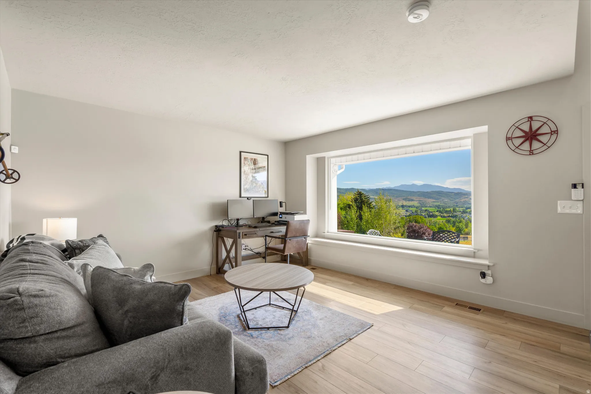 Expansive window framing a mountain and valley landscape