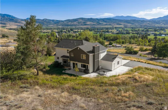 Contemporary multi-level residence with a prominent chimney structure and multiple windows