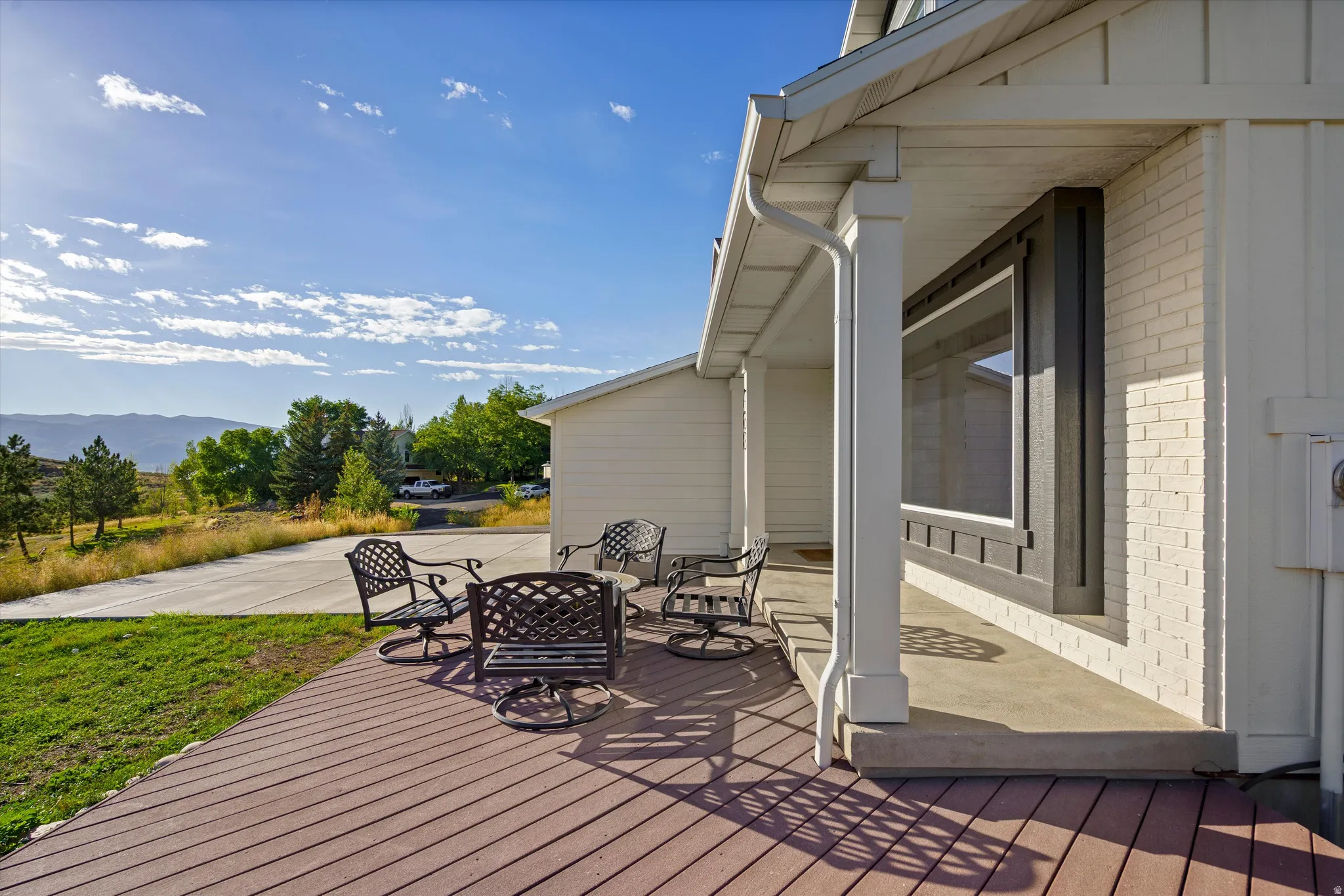 Expansive wood-finish deck with mountain backdrop
