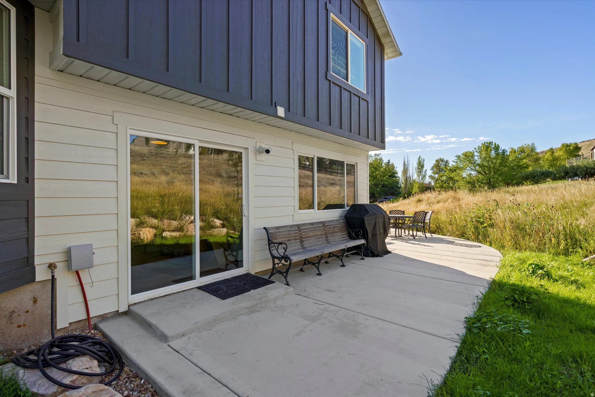 Concrete patio offering direct outdoor access via sliding glass doors