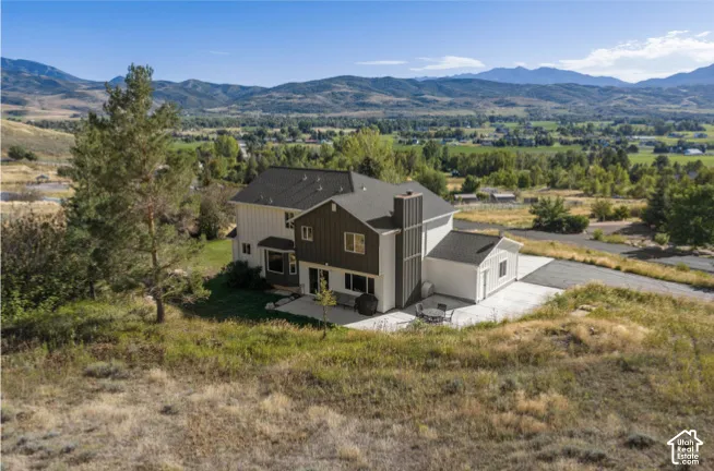 Contemporary multi-level residence with a prominent chimney structure and multiple windows