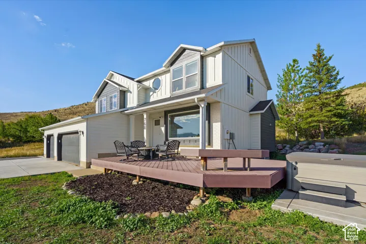 Two-story residence with a two-car garage, expansive outdoor deck, and a spa