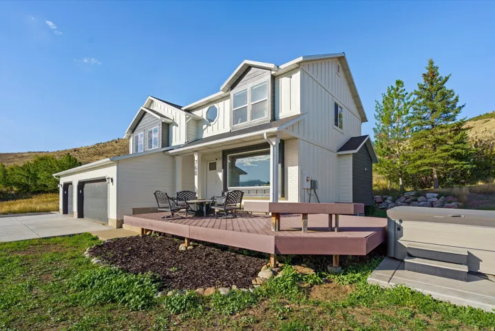 Two-story residence with a two-car garage, expansive outdoor deck, and a spa