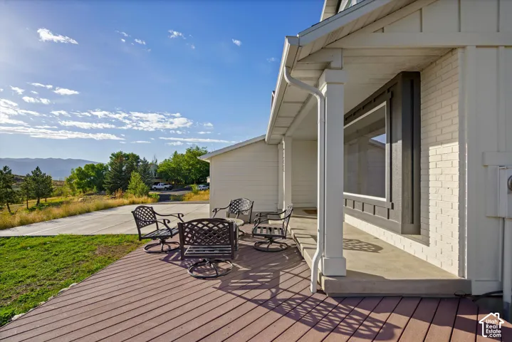 Expansive wood-finish deck with mountain backdrop