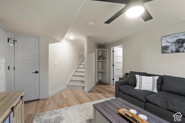 Wood-finish flooring throughout, recessed lighting, ceiling fan with integrated light, built-in shelving, and light gray interior doors with matte black hardware