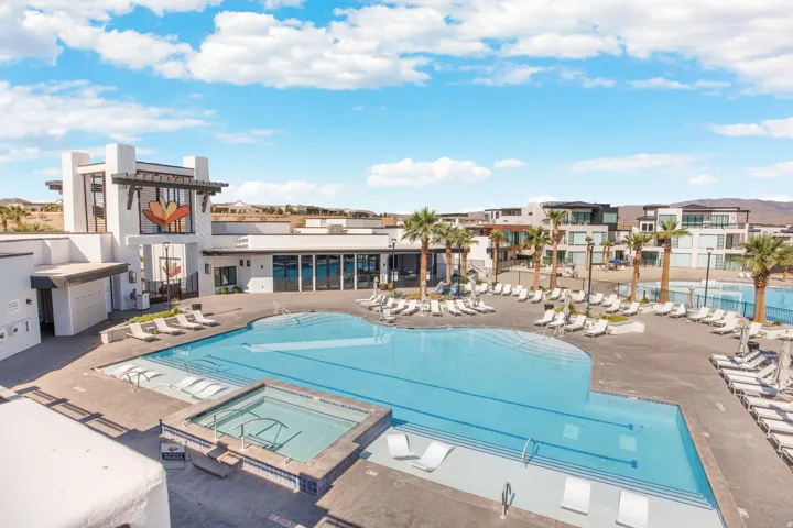 Expansive resort-style swimming pool, integrated spa, and spacious sundeck