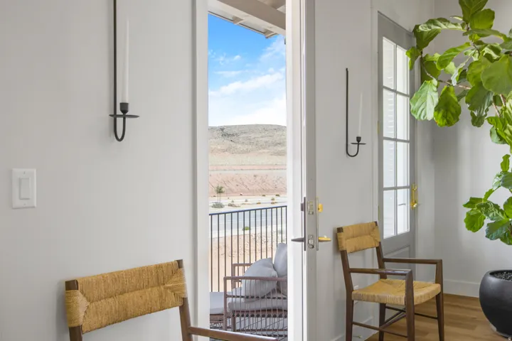 Entryway with wood-finish flooring, white walls, and a glass-paneled door