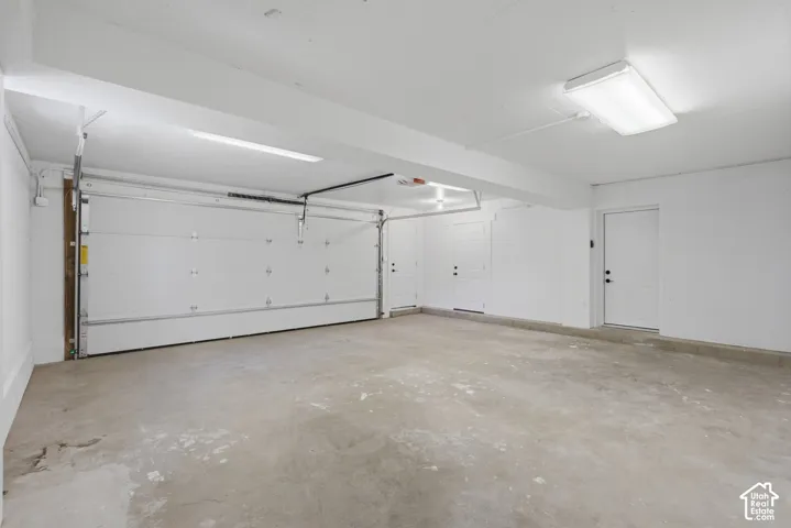 2 car garage with door opener and concrete floor