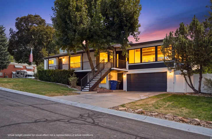 Brick rambler home, with upper-level balcony, and durably-crafted hand welded metal railings