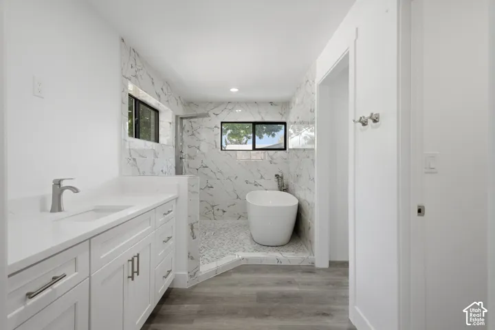 Classy freestanding soaking tub, walk-in shower with mosaic tile floor