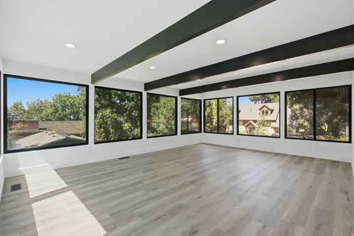 Stunning family room with exposed ceiling beams and recessed lighting