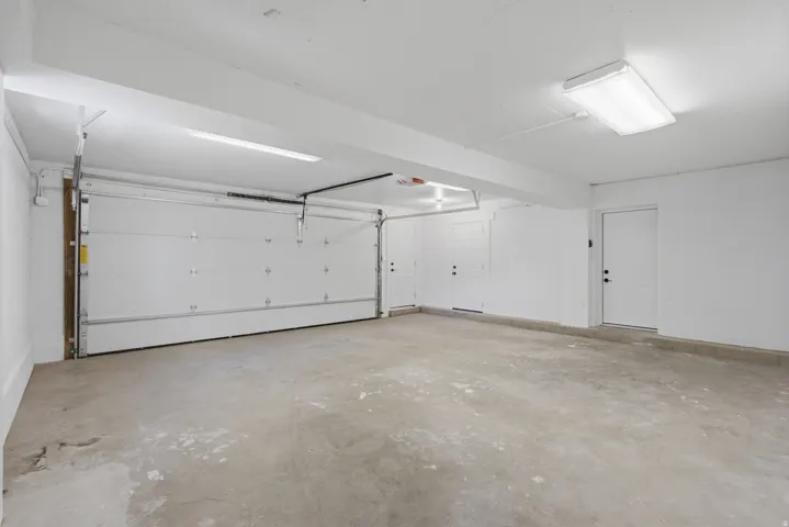 2 car garage with door opener and concrete floor