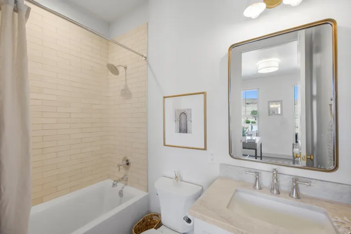 Contemporary bathroom featuring a white bathtub, subway tile shower surround, and chrome shower fixtures