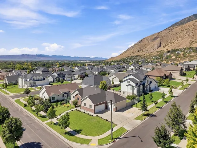 Residential neighborhood with mature landscaping and mountain backdrop