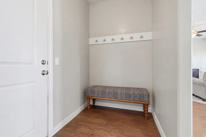 Entryway featuring wood-finish flooring and a built-in coat rack