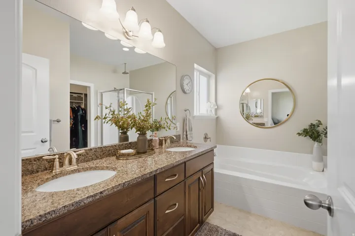 Dual vanity with stone-finish countertop, undermount sinks, and bronze-finish faucets