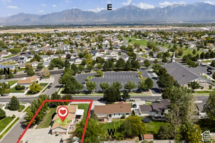 Aerial perspective of the property within a residential neighborhood