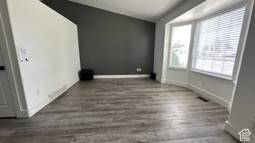 Living Room with tile flooring throughout, complemented by a bay window with blinds