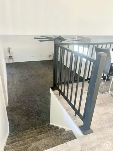 Multi Level Stairs to the family room, with Metal upgraded bars that match throughout the home.
